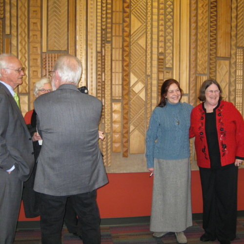 Lynda Ford Wynans and Kathy Strauss in front of Lynn Ford carving. Also pictured: architects, Boone Powell, on left, and Jane and Duane Landry.